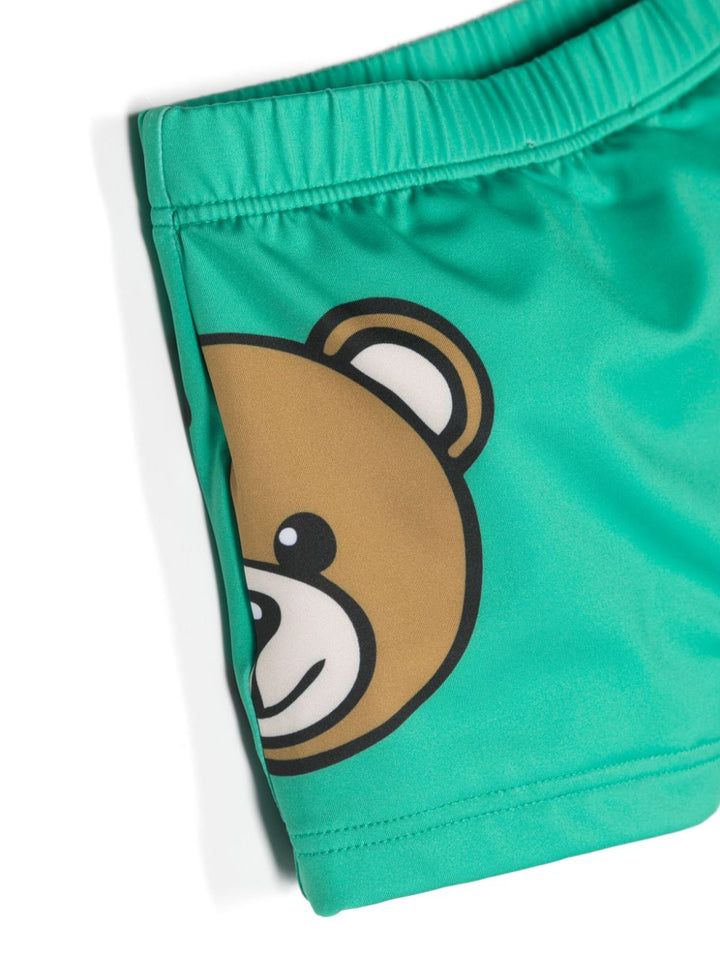 Green baby swim shorts with logo