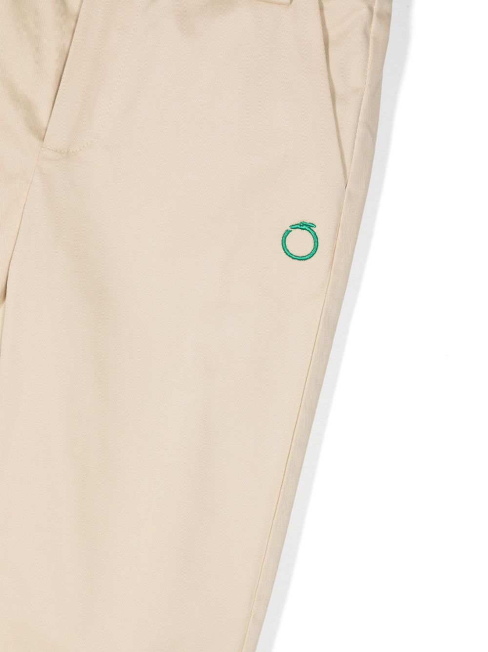 Beige trousers for children with green logo