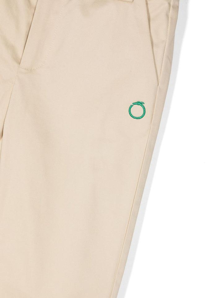 Beige trousers for children with green logo