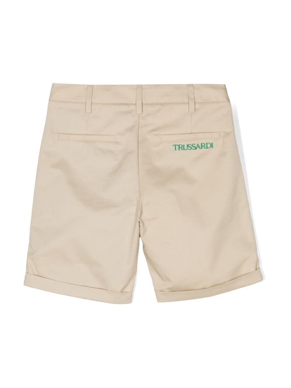 Bermuda beige per bambino con logo verde
