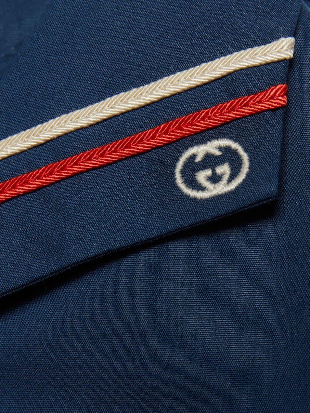 Pagliaccetto bianco e blu per neonato con logo