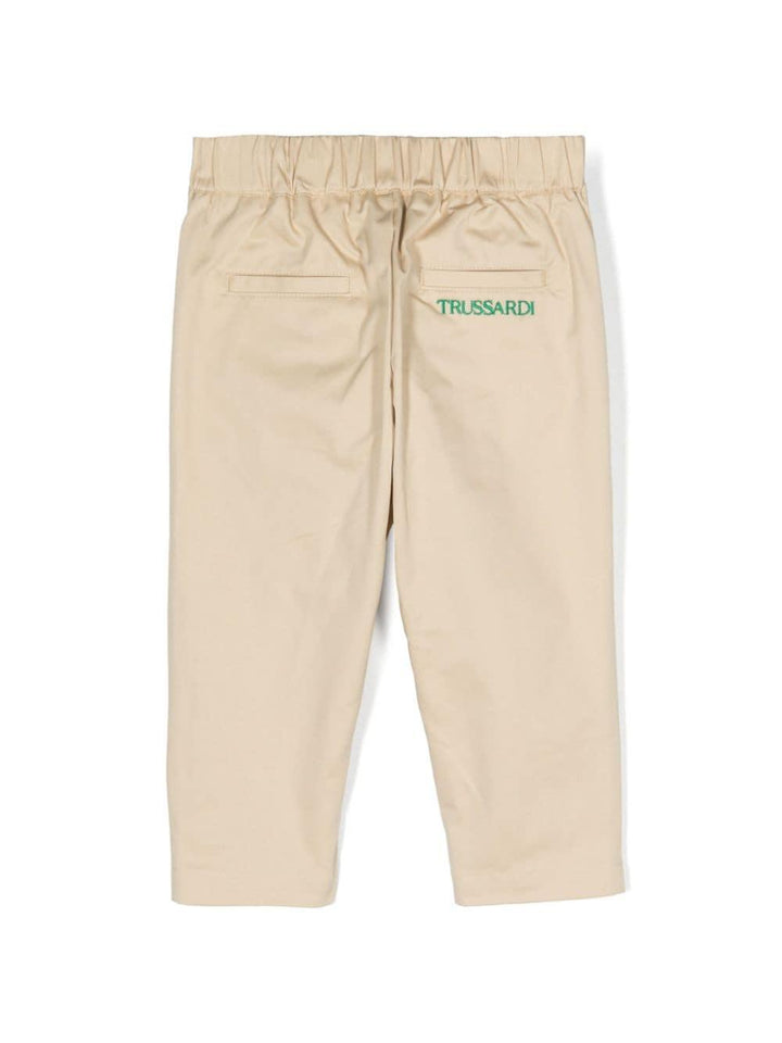 Beige baby trousers with green logo